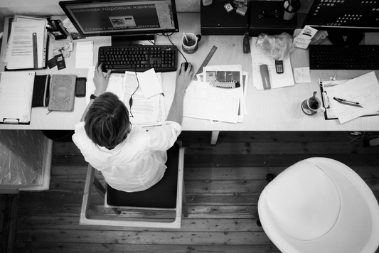 Overhead image of man working on a computer at a desk