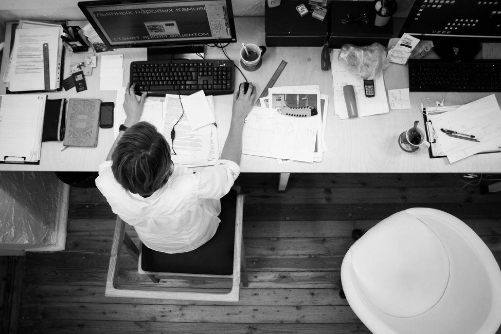 Overhead image of man working on a computer at a desk 